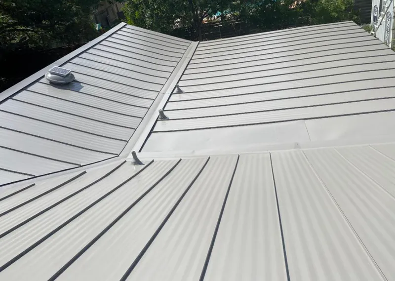 Solar attic fan installed on a metal roof for Roof Ventilation in Aventura